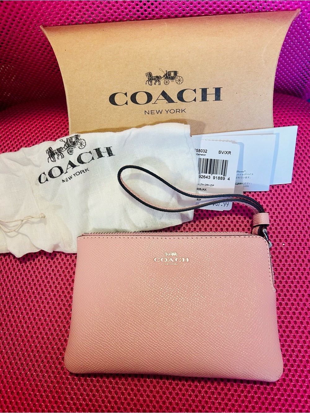New Coach Pink Leather Wristlet with Pink strap with Silver embossed lettering.
